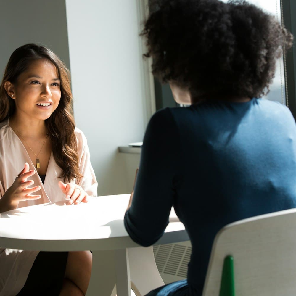A candidate in conversation with a recruiter across a table
