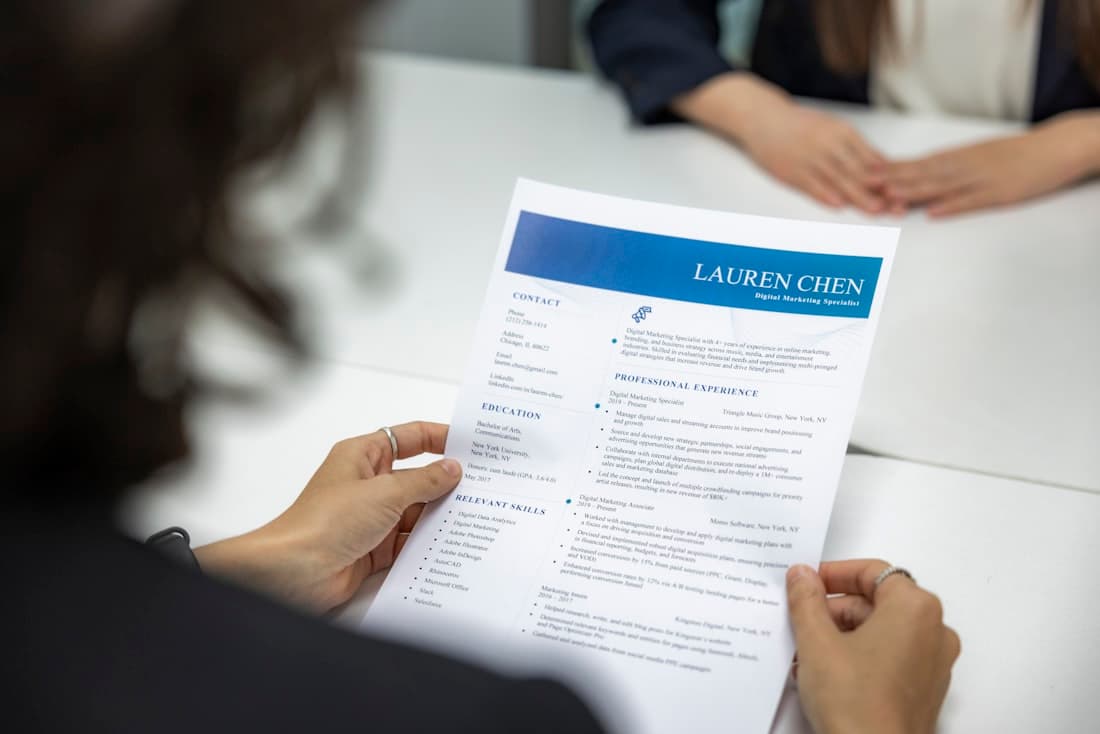 A recruiter reading a printed CV during an interview